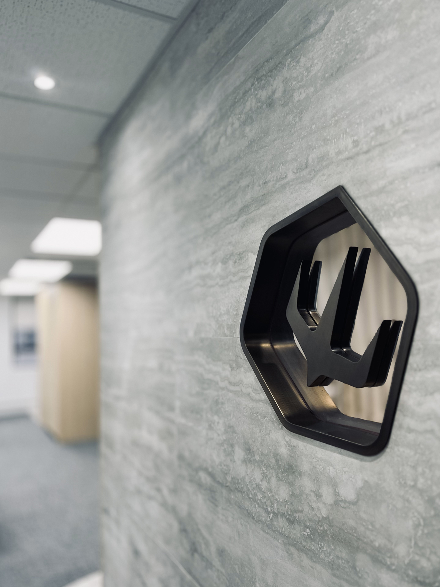 Charterama Office Renovation with tile, wood louvers and stainless steel signage