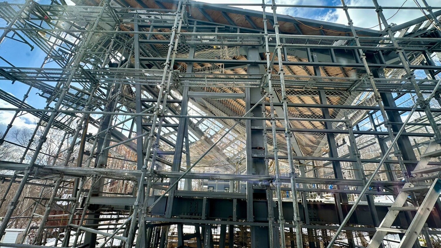 scafollding and framing of a steel frame post and beam house construction site with a triangular roof in Niseko, Kutchan Hokkaido Japan